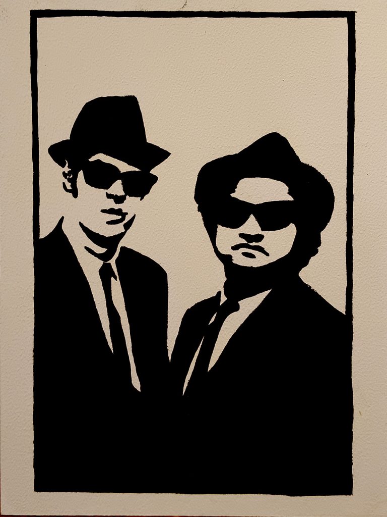 Silueta en blanco y negro de los Blues Brothers con traje, sombrero y gafas de sol