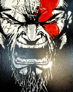 Pintura acrílica de Kratos de God of War sobre tabla de DM, primer plano con marca roja característica.