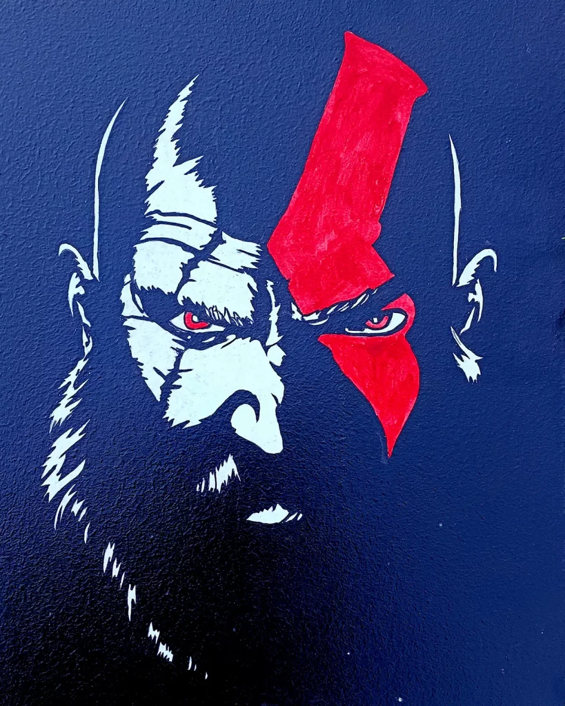 Pintura acrílica del rostro de Kratos de God of War con su característica marca roja, en blanco y rojo sobre fondo azul marino, pintada a mano sobre tabla de DM.